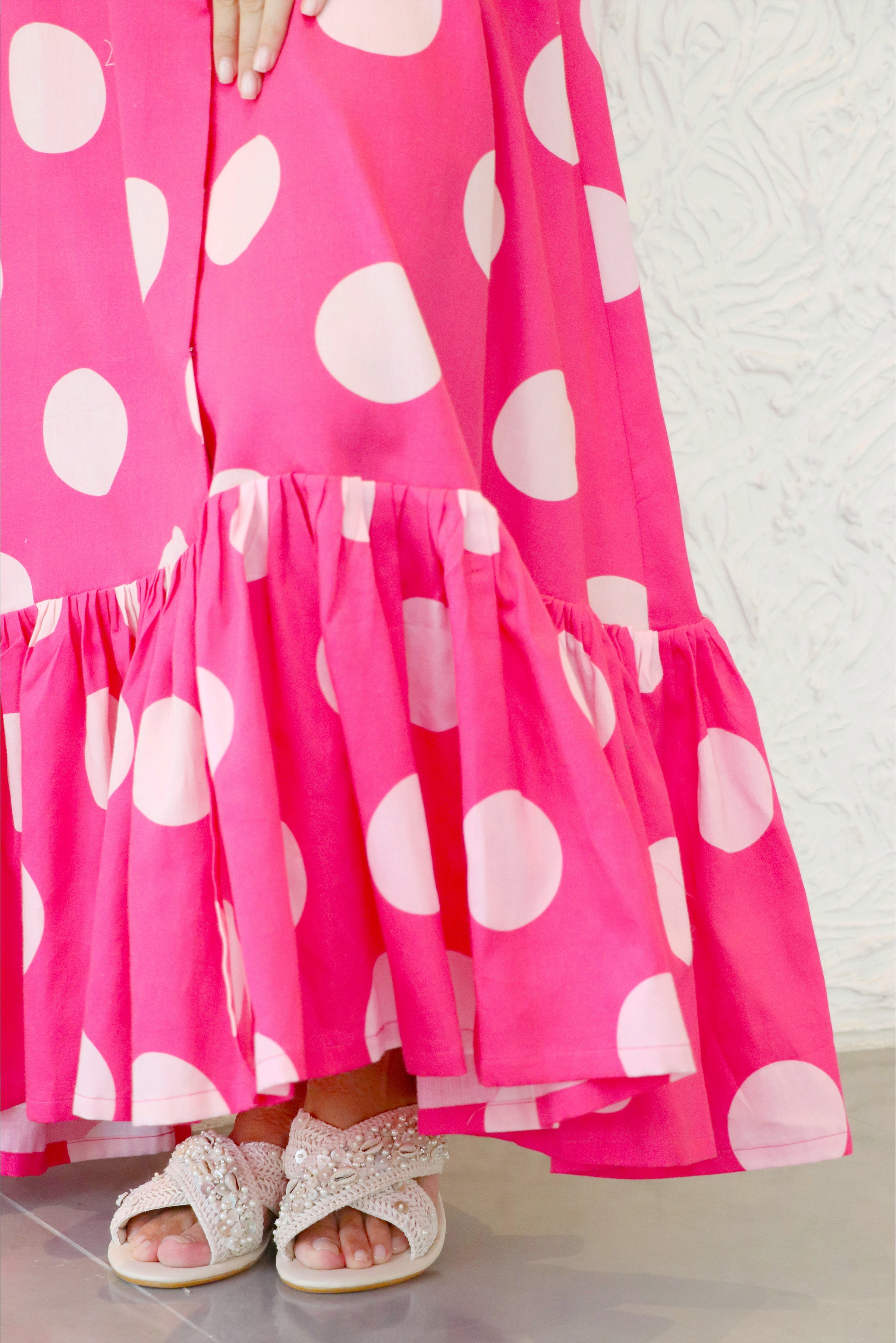 Close-up of the glazed cotton fabric on Aine's polka dot midi dress.