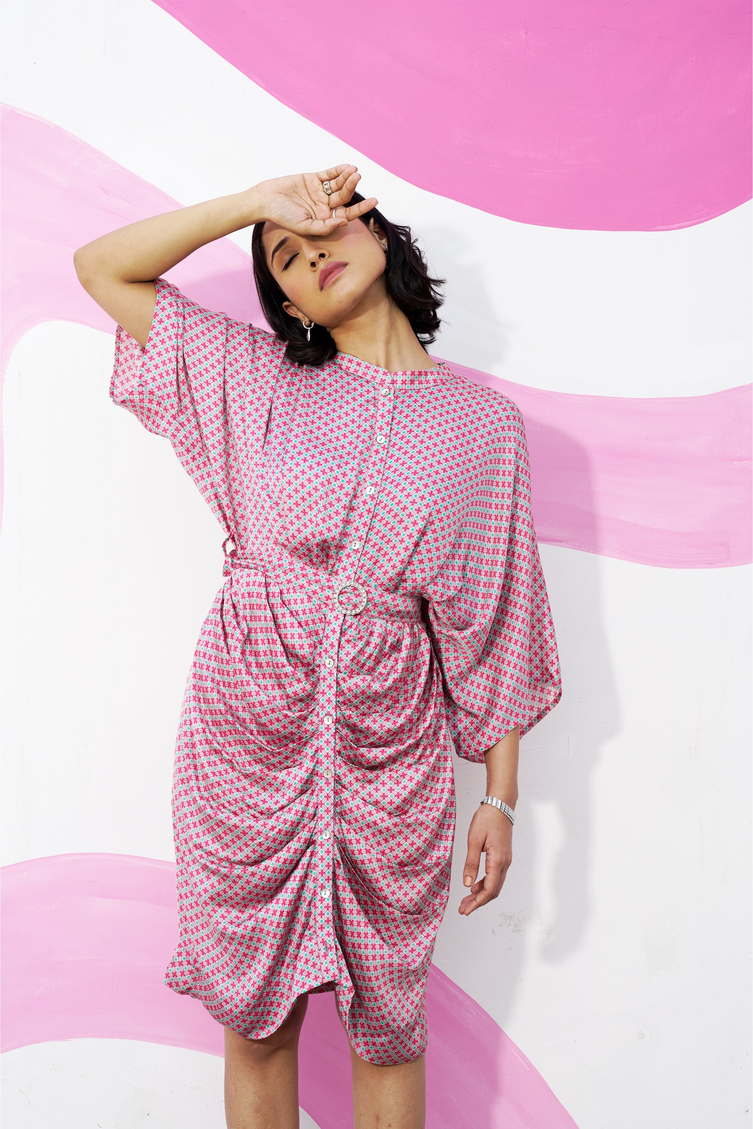 Fashionable pink and white striped button-down shirt with long sleeves and collar.