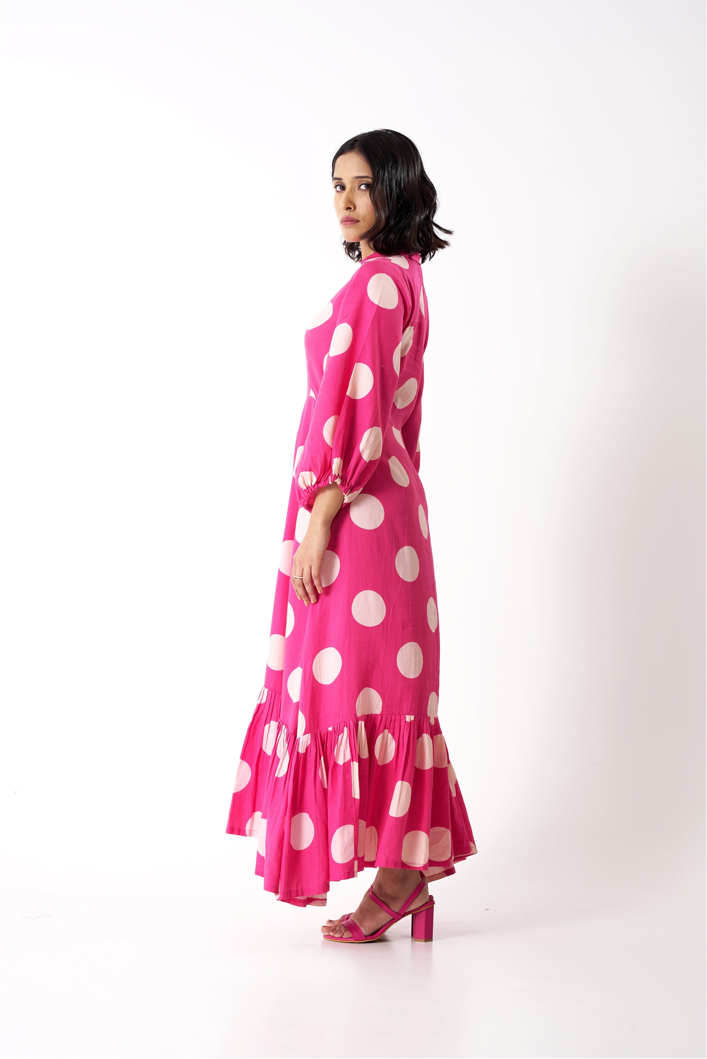 Aine's polka dot midi dress in a flattering A-line silhouette, side view.