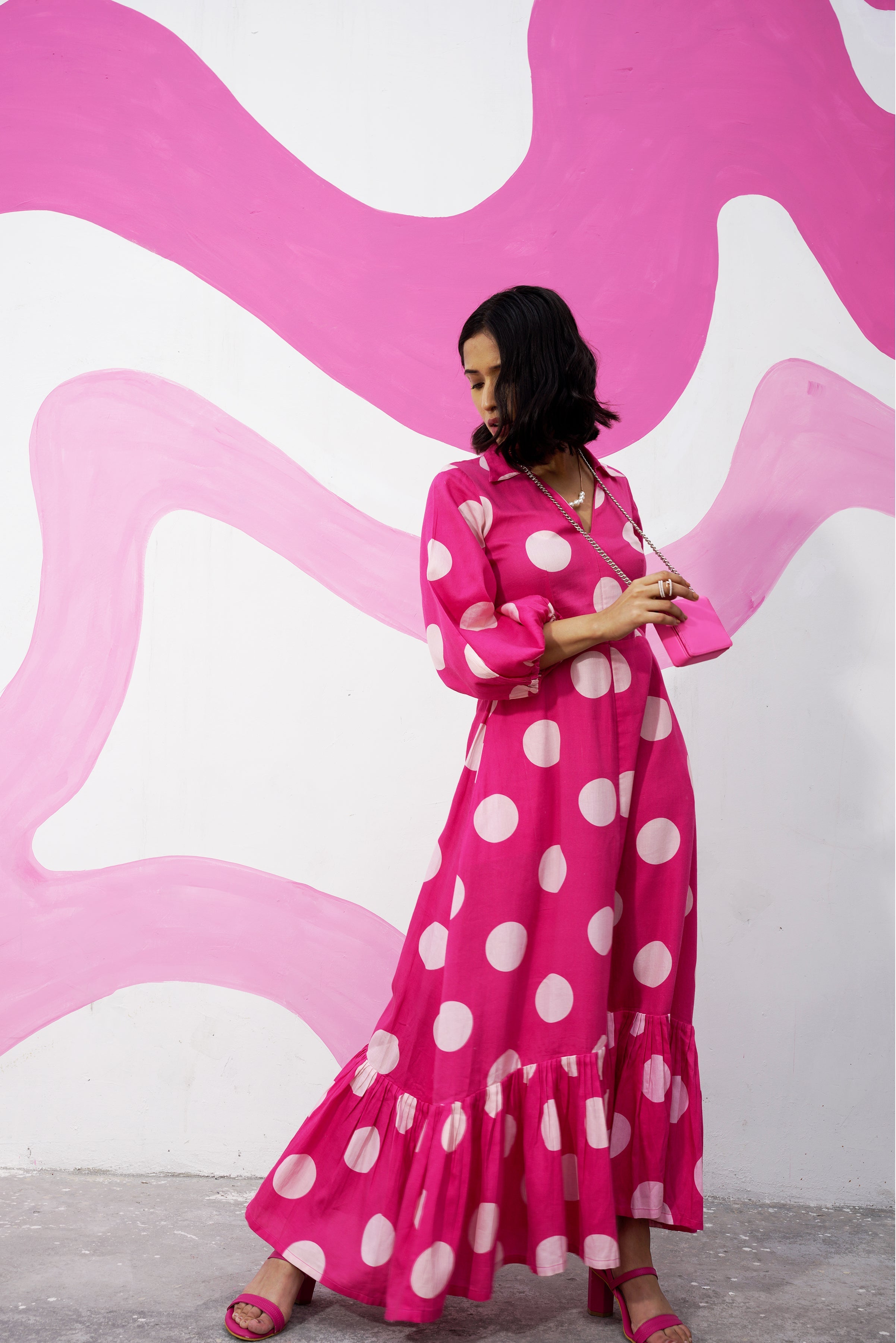 Aine's polka dot midi dress in a aesthetic setting, paired with sandals.