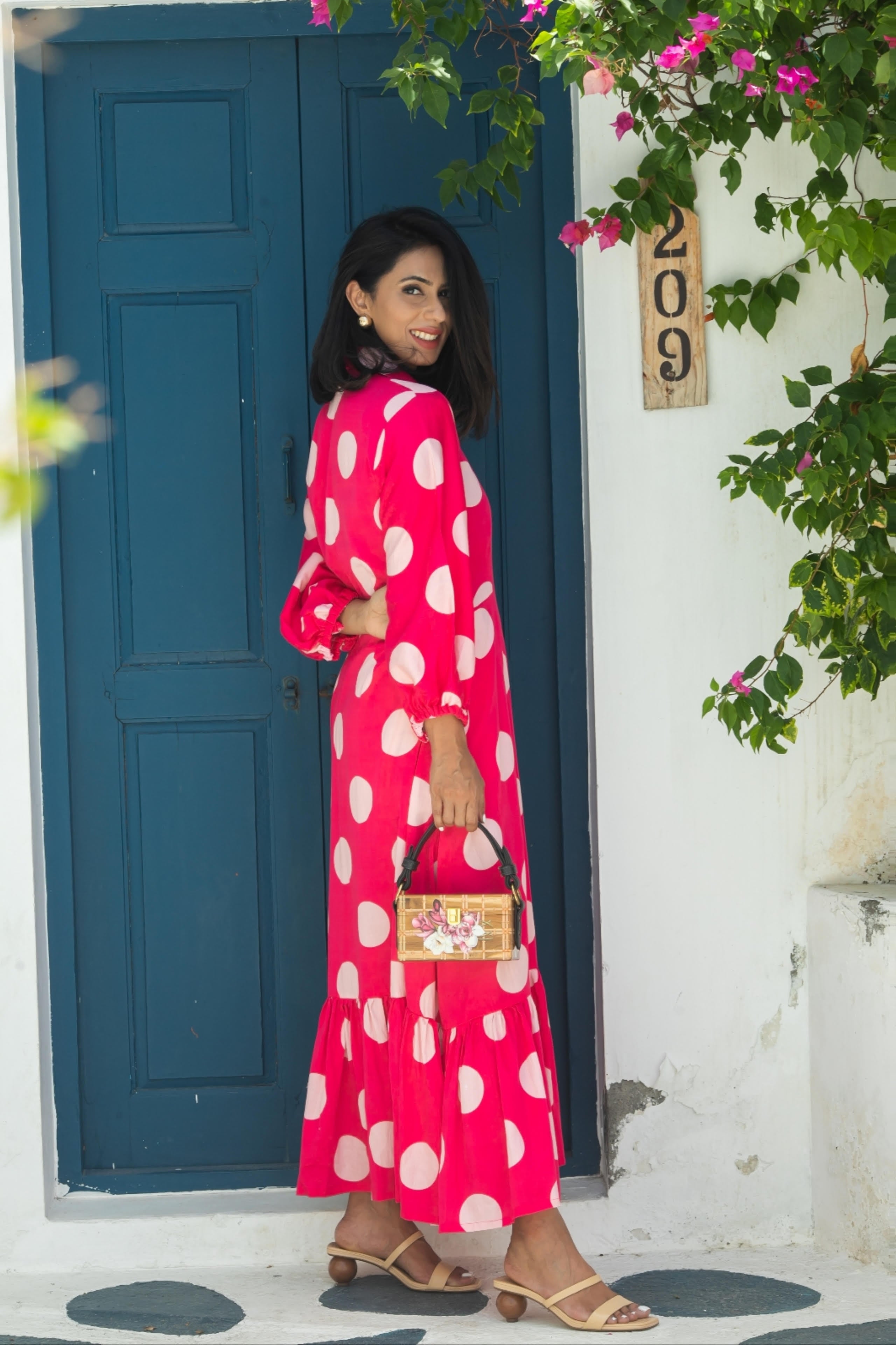 Aine's polka dot midi dress in glazed cotton, styled for a formal event